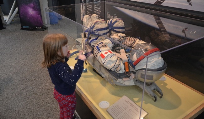 Six-Year-Old Abigail Enthralled By Canadian Astronaut Chris Hadfield's Sokol spacesuit