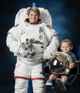 NASA Astronaut Anne McClain with her son posing for her professional NASA Astronaut Portrait