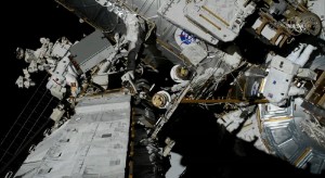 NASA Astronauts Christina Koch (EV1 - red stripe) and Jessica Meir carrying out the first all-woman spacewalk on Friday 18th October, 2019 and making history [image: NASA TV screenshot]